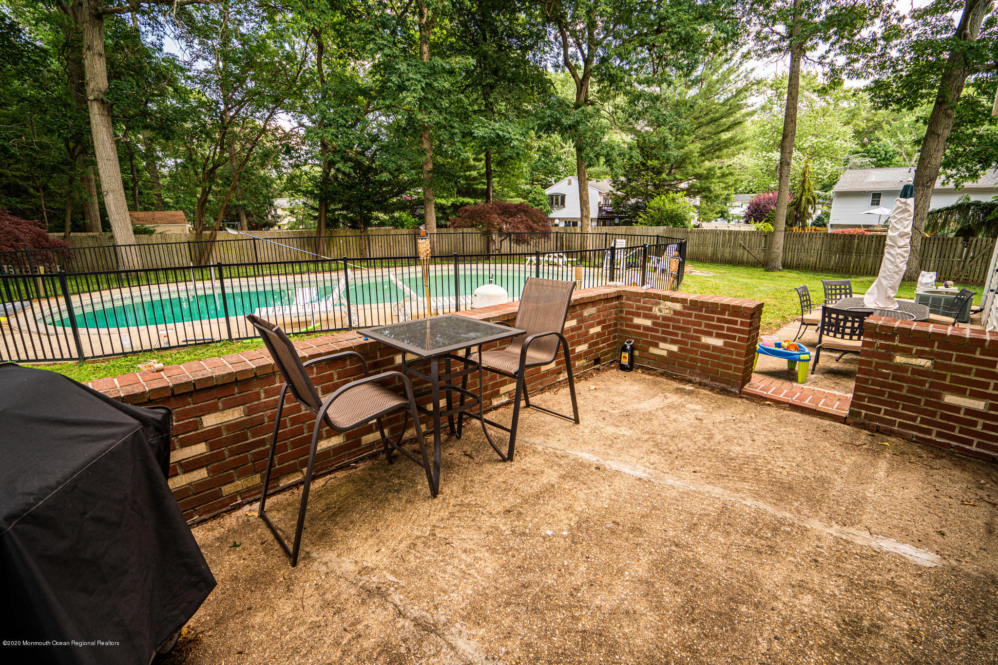 28 Holiday Road Manalapan, NJ 07726 - Photo 19 of 27 a view of a chairs and table in the back yard