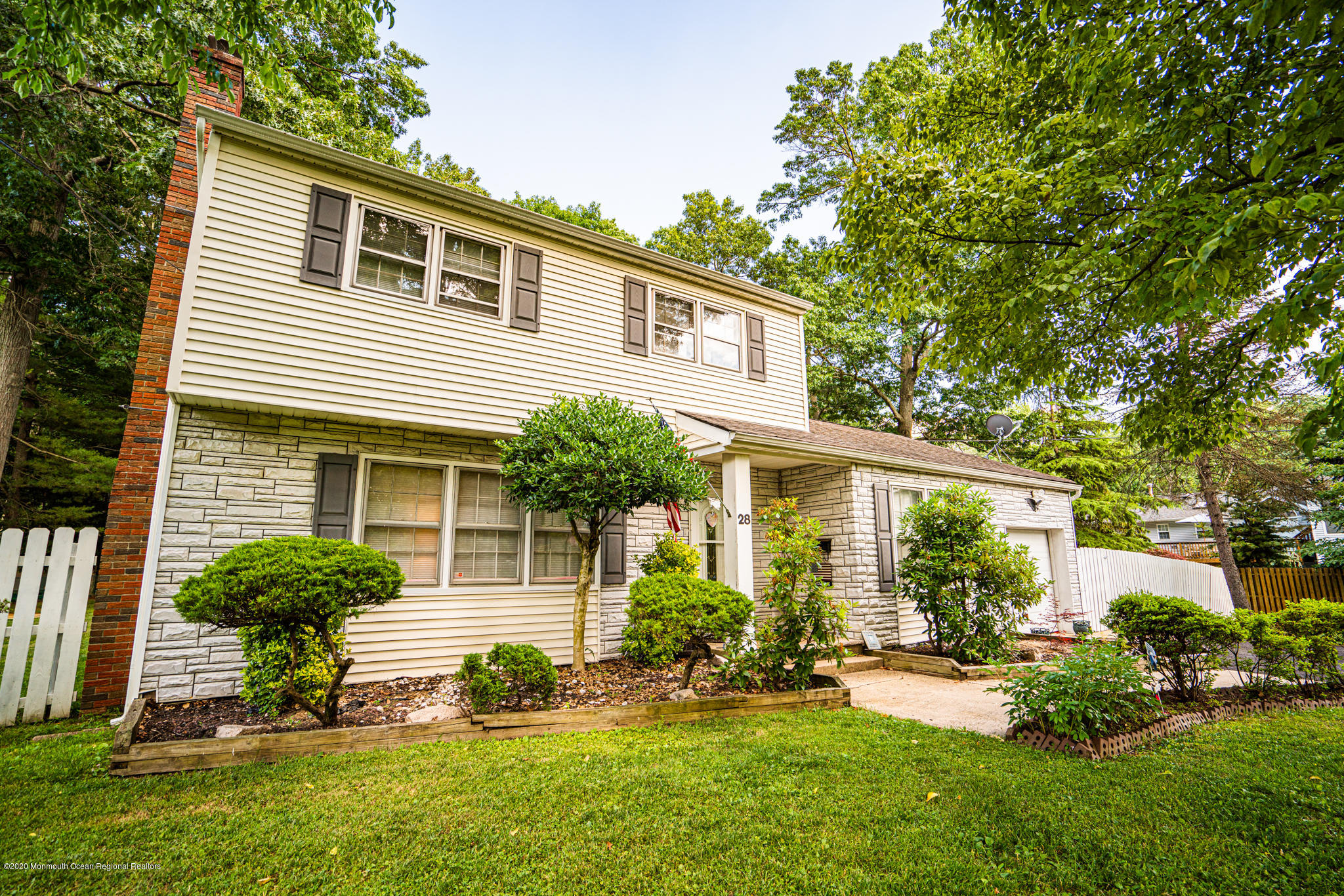 28 Holiday Road Manalapan, NJ 07726 - Photo 2 of 27 a view of a house with a yard and a garden