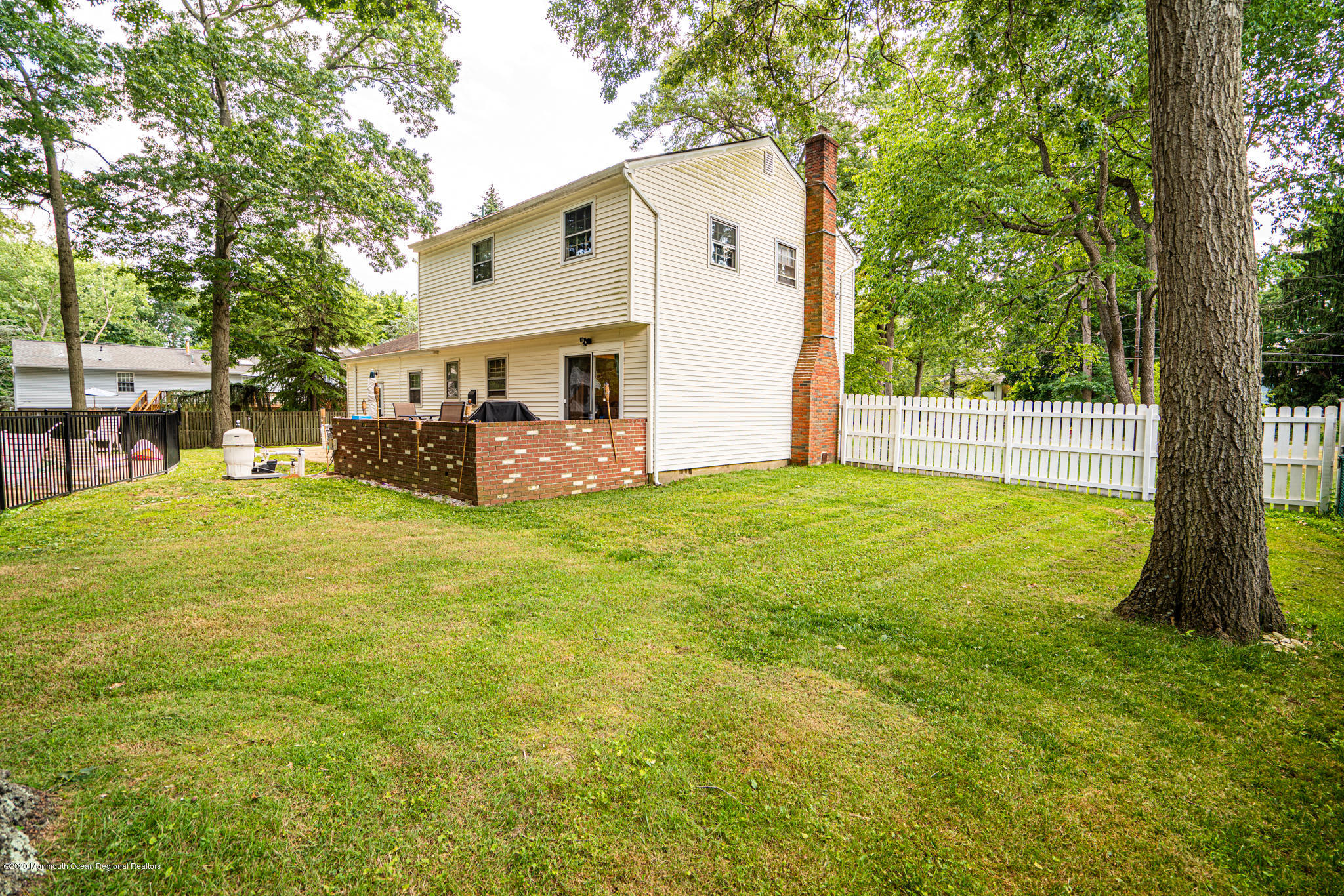 28 Holiday Road Manalapan, NJ 07726 - Photo 21 of 27 a view of a house with backyard and a tree