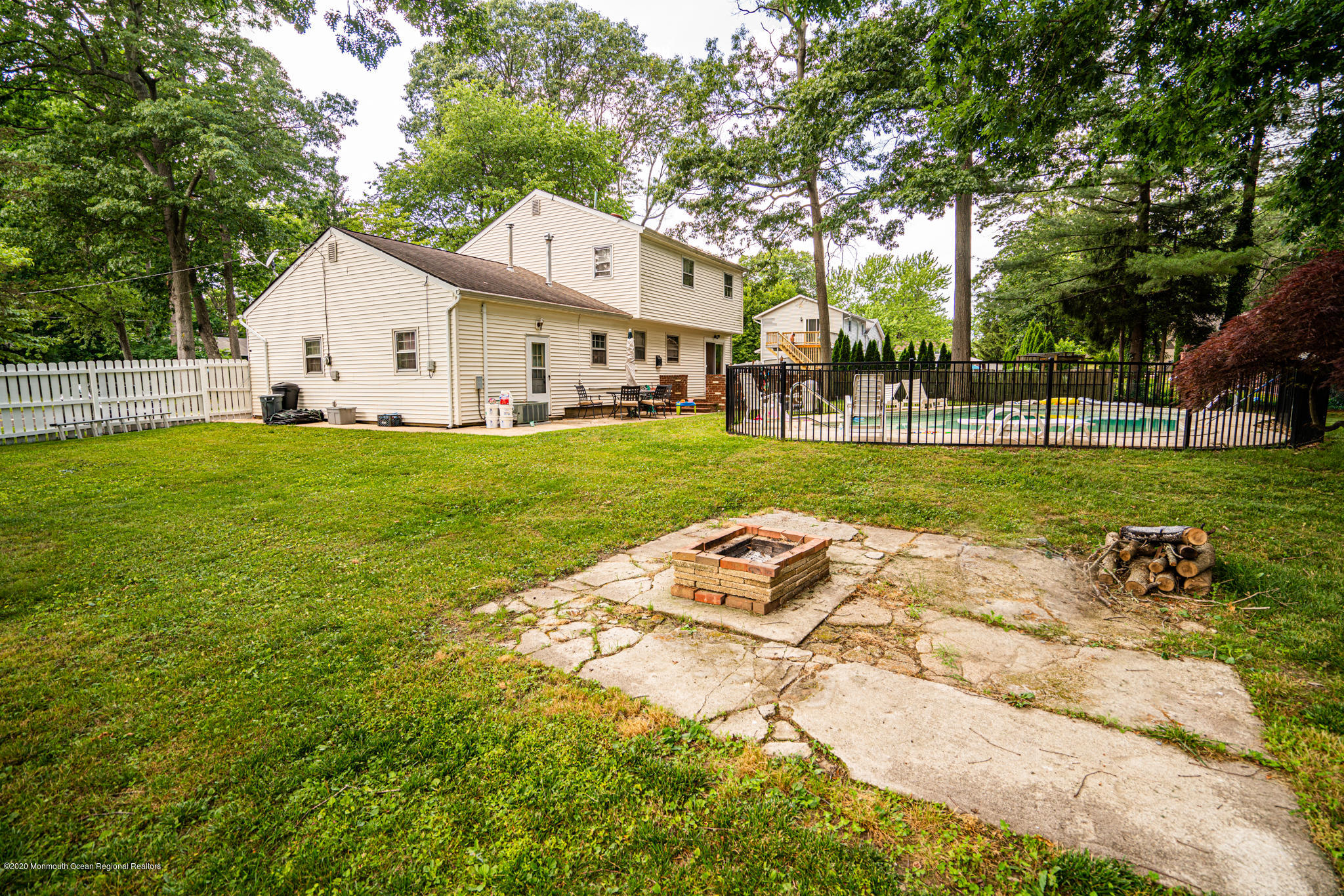 28 Holiday Road Manalapan, NJ 07726 - Photo 23 of 27 a view of a house with a yard and sitting area