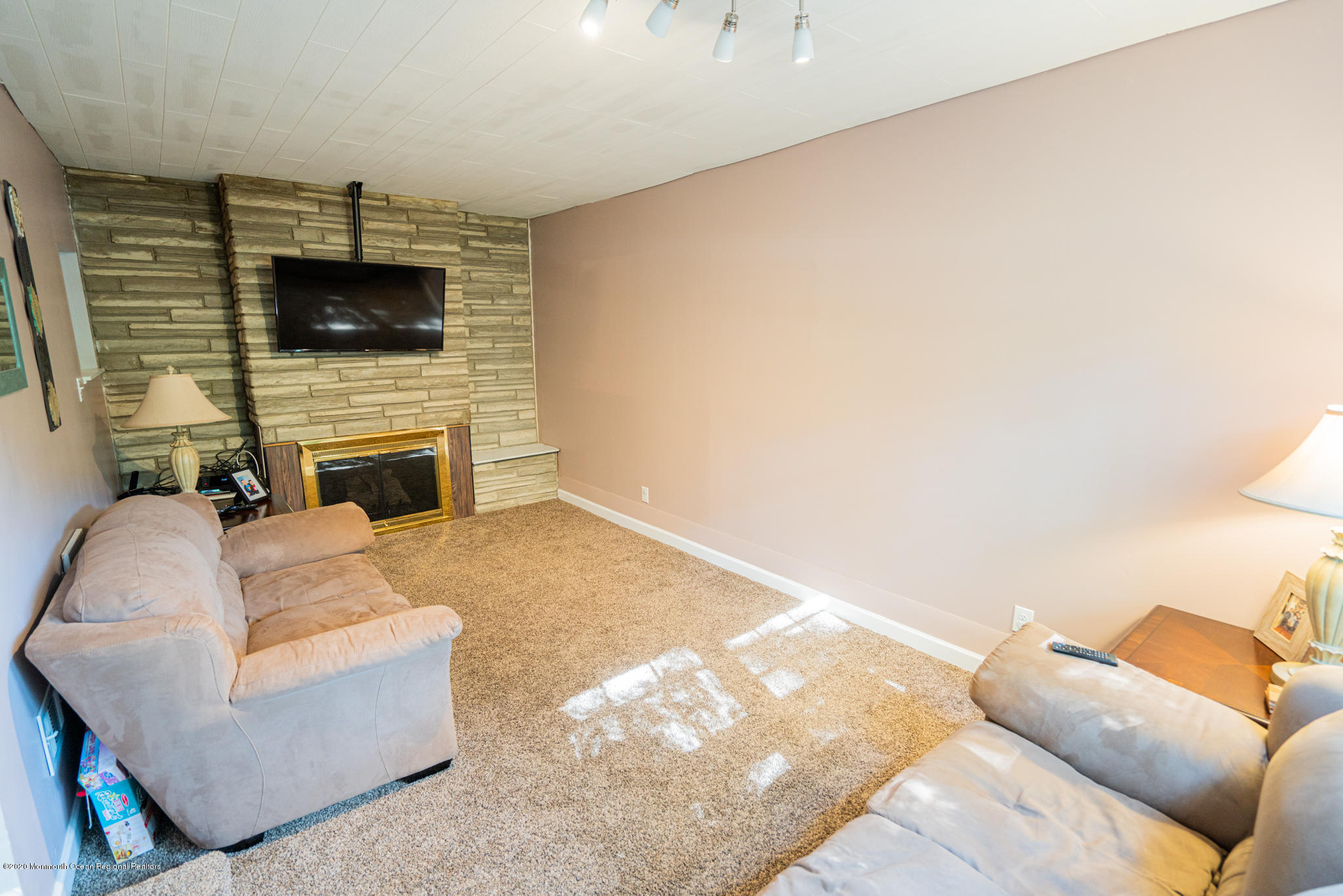 28 Holiday Road Manalapan, NJ 07726 - Photo 9 of 27 a living room with furniture and a flat screen tv
