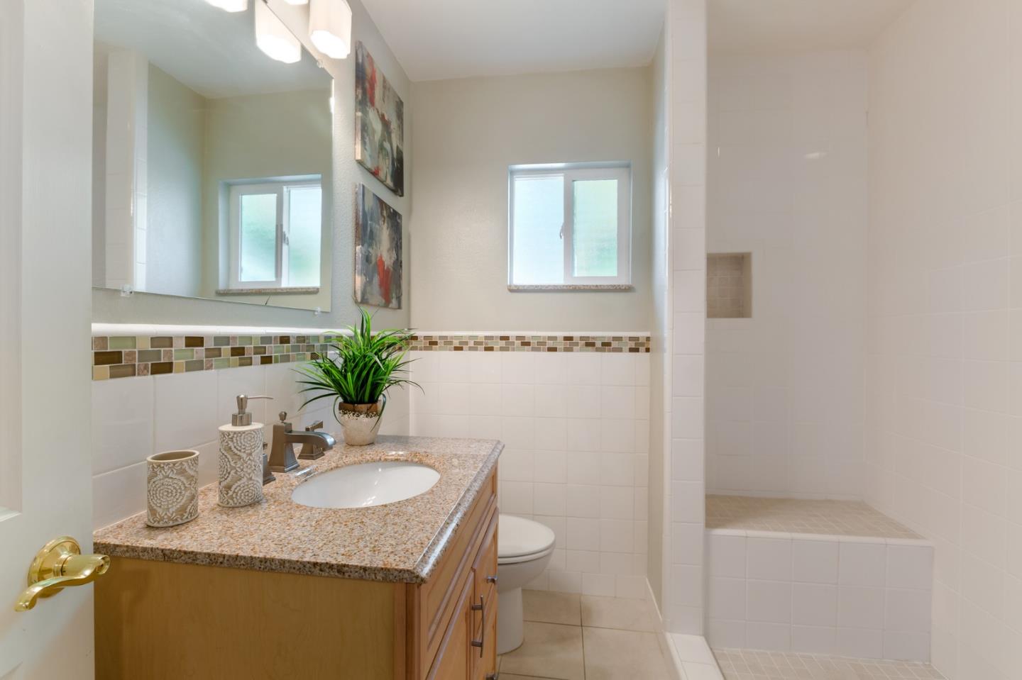 645 Chapman Drive Campbell, CA 95008 - Photo 18 of 33 a bathroom with a granite countertop sink a toilet and a mirror