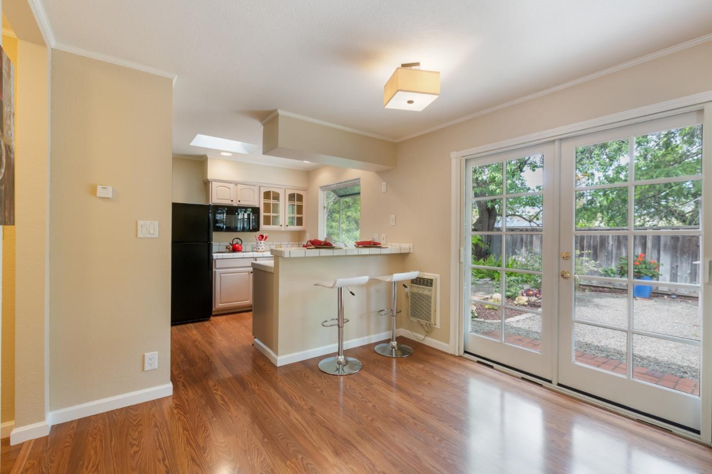 645 Chapman Drive Campbell, CA 95008 - Photo 23 of 33 a kitchen with white cabinets and wooden floor