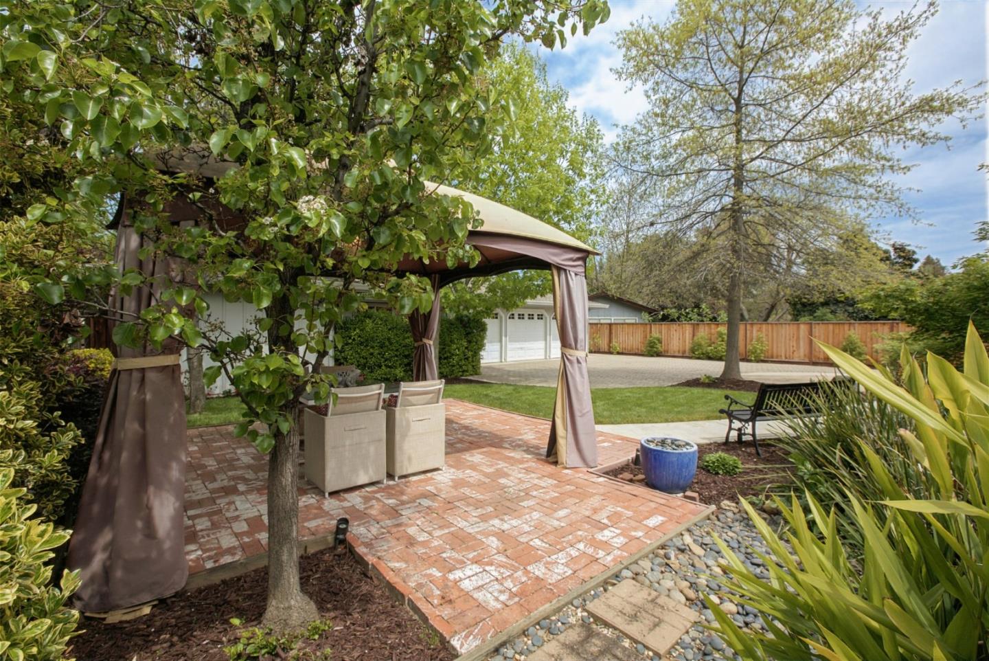 645 Chapman Drive Campbell, CA 95008 - Photo 30 of 33 a view of a backyard with table and chairs potted plants and large tree