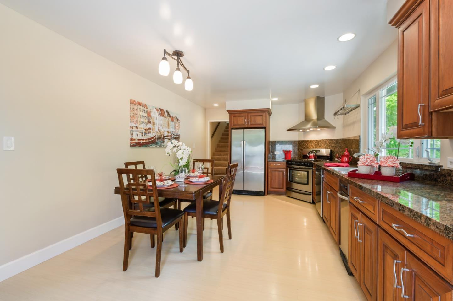 645 Chapman Drive Campbell, CA 95008 - Photo 6 of 33 a kitchen with stainless steel appliances kitchen island granite countertop a table chairs sink and cabinets