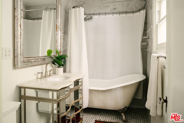 a white bath tub sitting next to a white sink