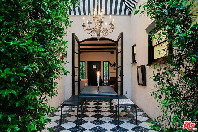 a view of a two chairs in the patio of a house