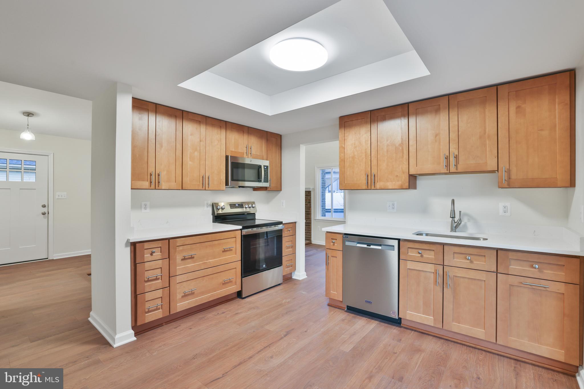 36 Thrush Road Sterling, VA 20164 - Photo 16 of 35 a kitchen with granite countertop a stove top oven sink and cabinets