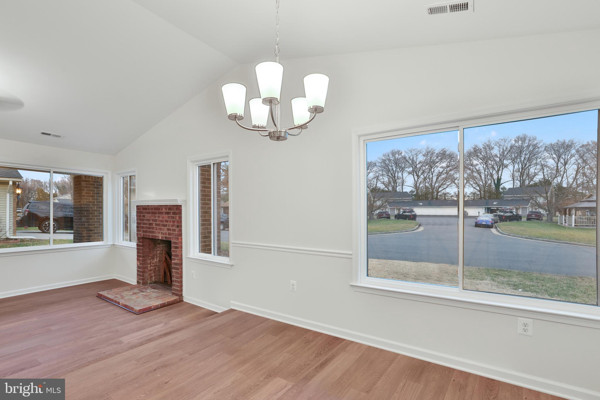 36 Thrush Road Sterling, VA 20164 - Photo 21 of 35 a view of a livingroom with a large window wooden floor and brick wall