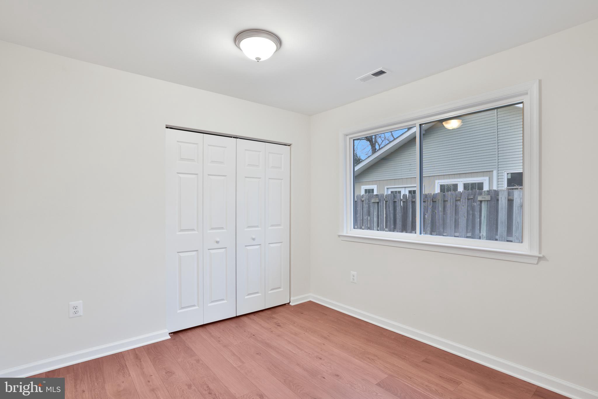 36 Thrush Road Sterling, VA 20164 - Photo 25 of 35 an empty room with wooden floor and windows
