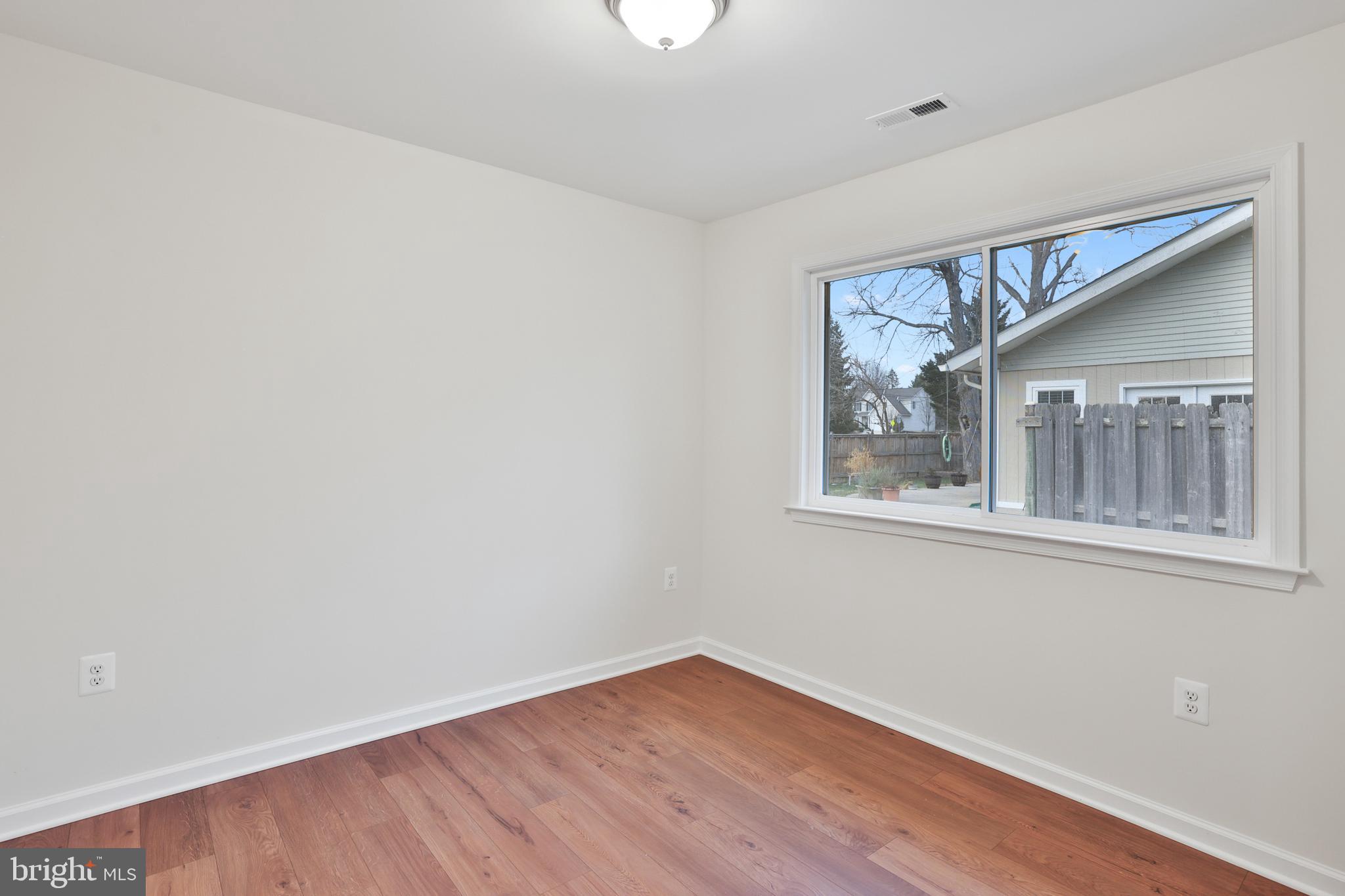 36 Thrush Road Sterling, VA 20164 - Photo 27 of 35 a view of an empty room with wooden floor and a window