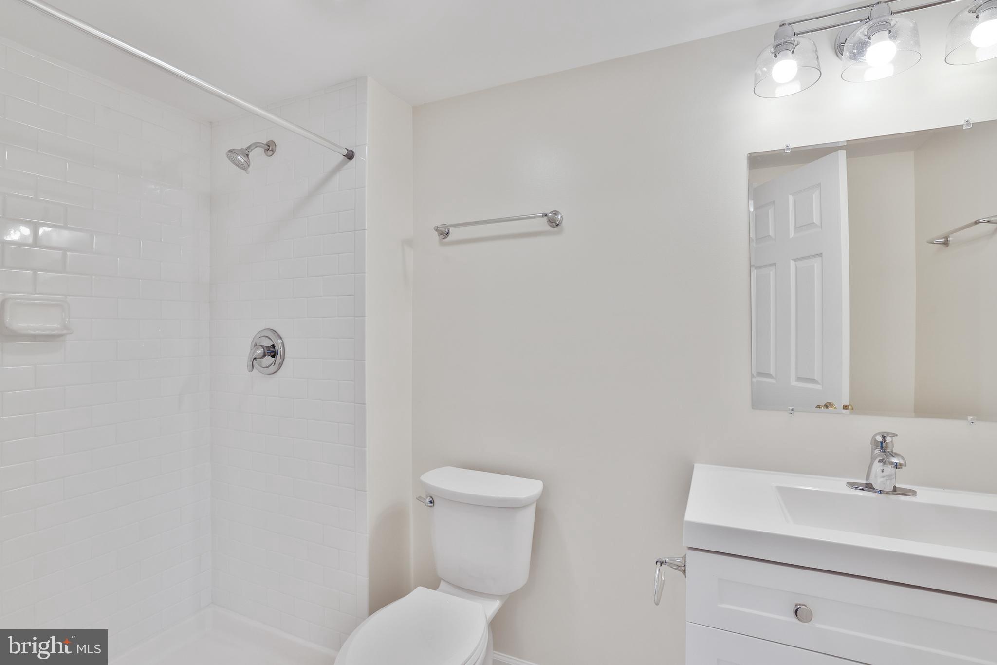 36 Thrush Road Sterling, VA 20164 - Photo 34 of 35 a bathroom with a toilet a sink a mirror and vanity
