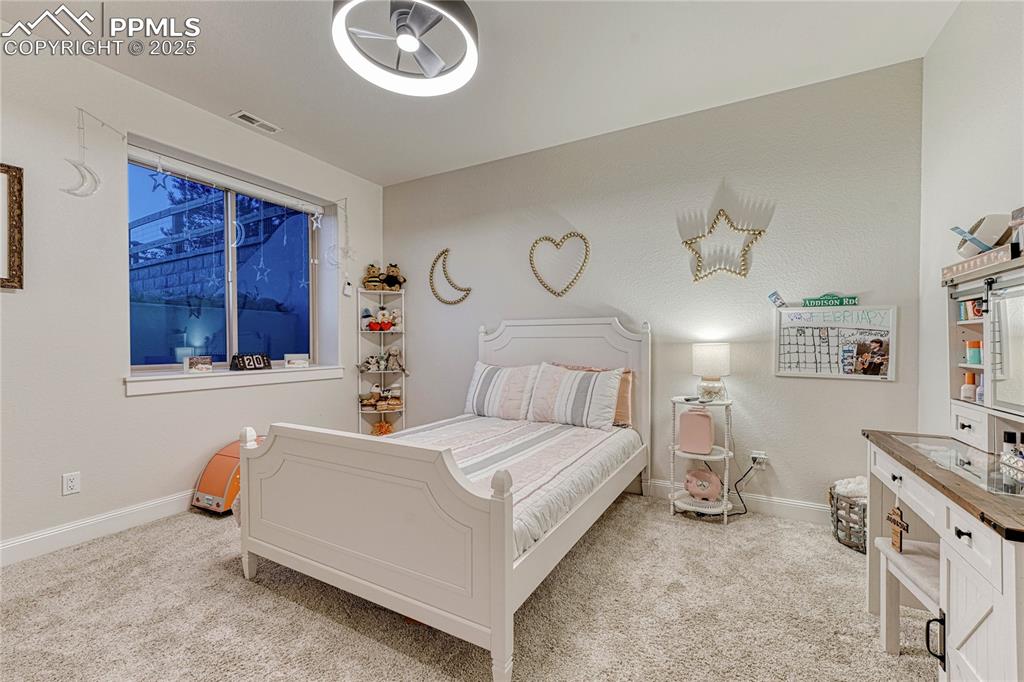 18762 Cherry Springs Ranch Drive Monument, CO 80132 - Photo 26 of 50 a bedroom with a bed and a table in it