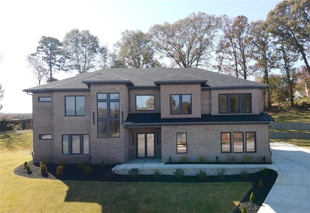 a front view of a house with a yard and garage