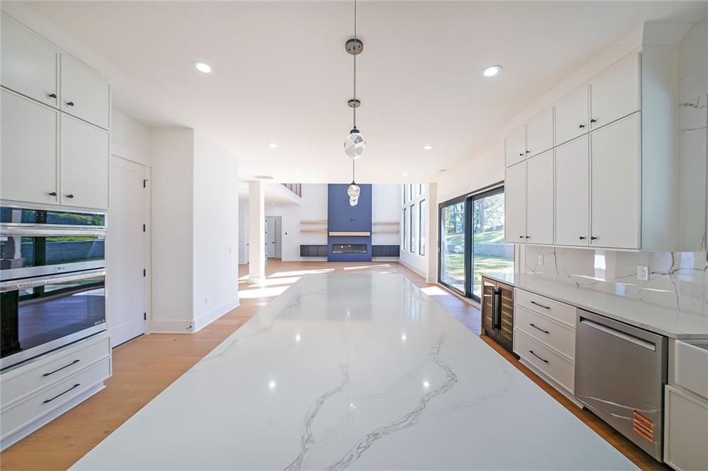 156 Rocky Ridge Way Auburn, GA 30011 - Photo 13 of 56 a kitchen with stainless steel appliances granite countertop a sink a stove and a refrigerator