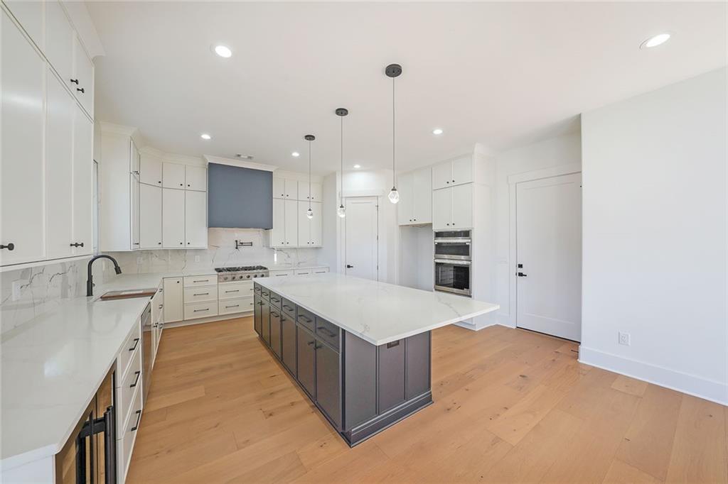 156 Rocky Ridge Way Auburn, GA 30011 - Photo 14 of 56 a large kitchen with a large counter top a sink stainless steel appliances and cabinets