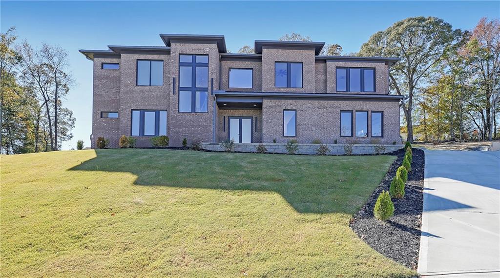 156 Rocky Ridge Way Auburn, GA 30011 - Photo 2 of 56 a large brick building with a yard in front of it
