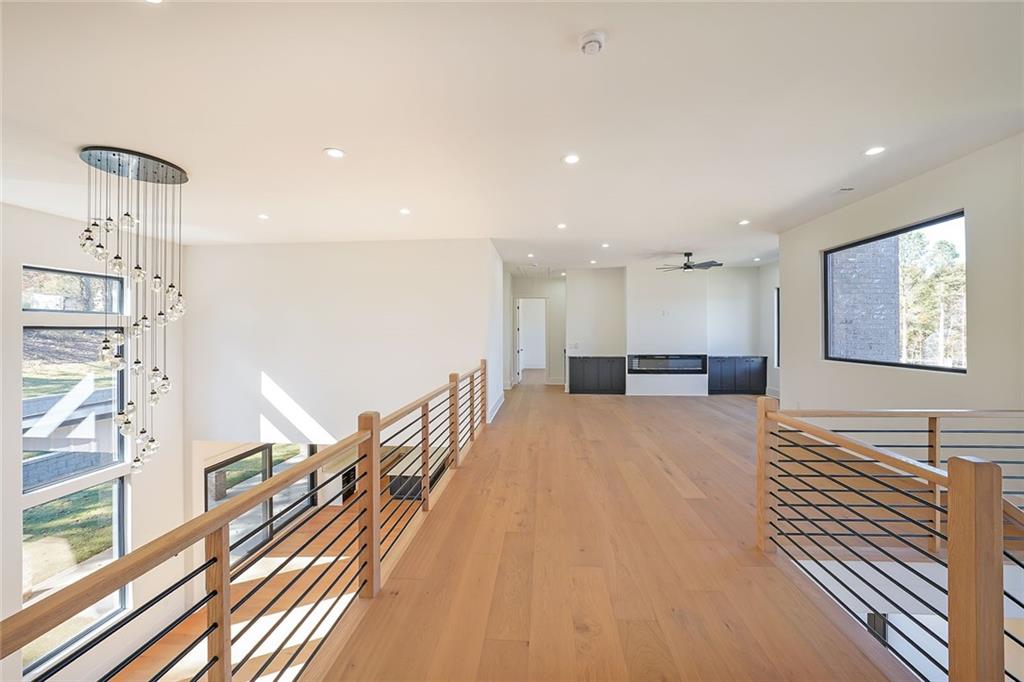 156 Rocky Ridge Way Auburn, GA 30011 - Photo 30 of 56 a view of a living room and kitchen with furniture wooden floor and windows