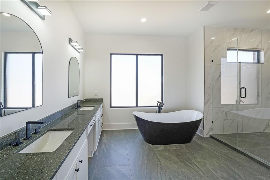 156 Rocky Ridge Way Auburn, GA 30011 - Photo 33 of 56 a spacious bathroom with a granite countertop tub and 2 sink