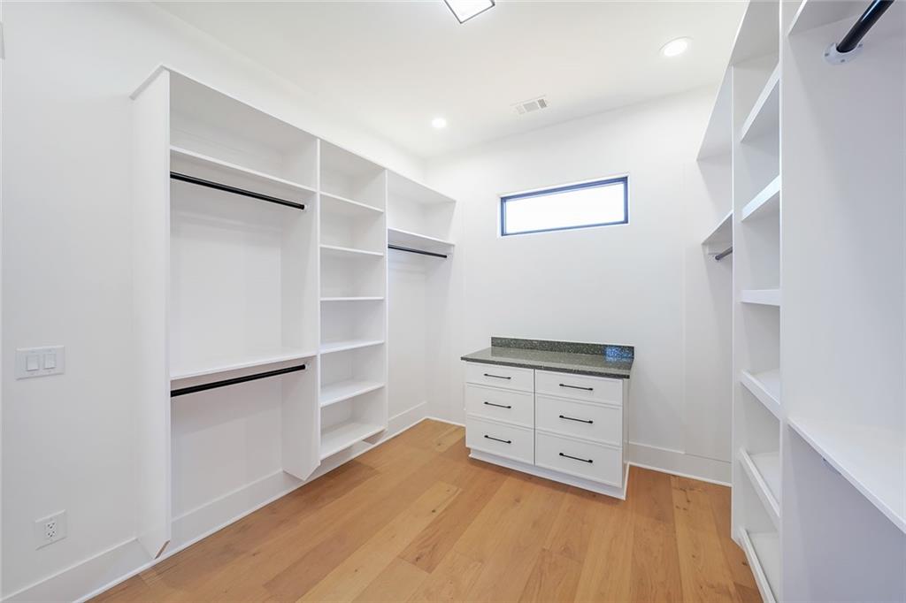 156 Rocky Ridge Way Auburn, GA 30011 - Photo 35 of 56 a view of an empty room with cabinet and wooden floor