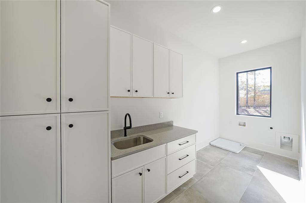 156 Rocky Ridge Way Auburn, GA 30011 - Photo 48 of 56 a kitchen with white cabinets and sink