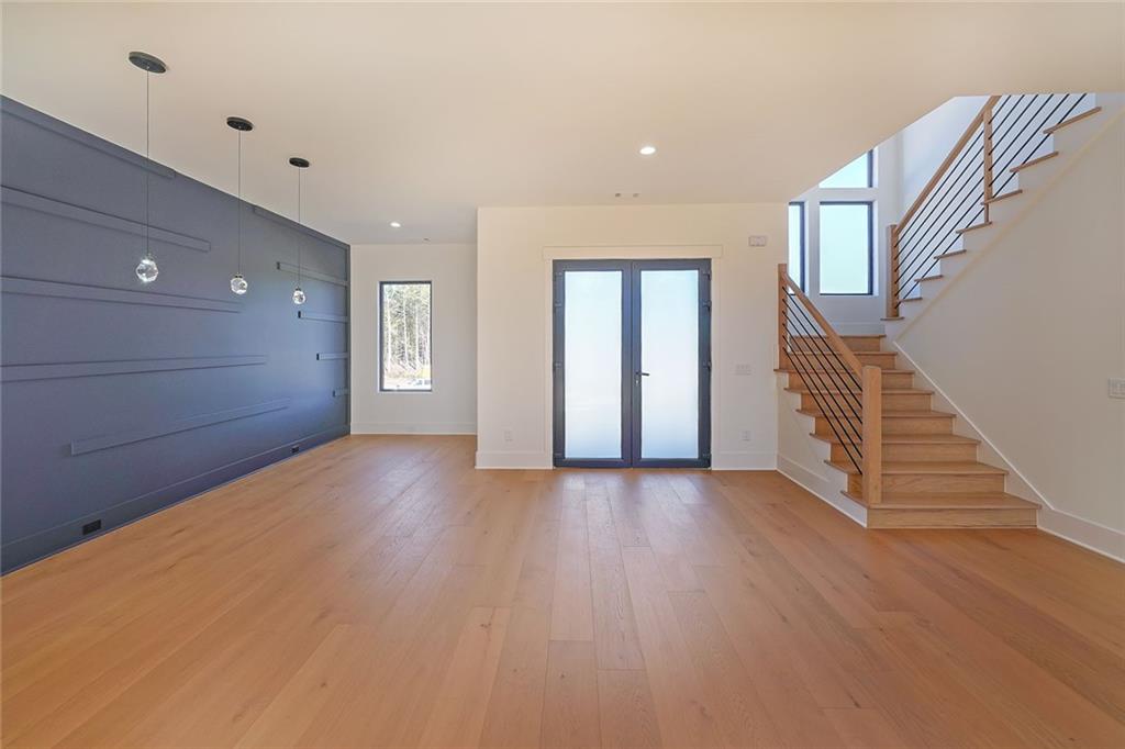 156 Rocky Ridge Way Auburn, GA 30011 - Photo 5 of 56 a view of an empty room with wooden floor and stairs