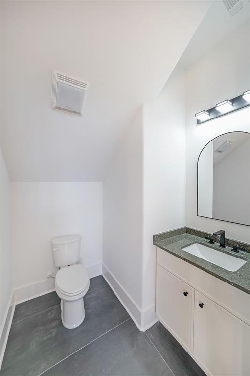 156 Rocky Ridge Way Auburn, GA 30011 - Photo 51 of 56 a bathroom with a granite countertop toilet and a sink