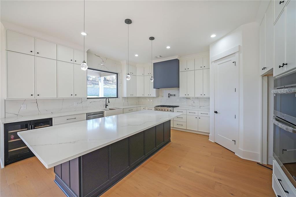 156 Rocky Ridge Way Auburn, GA 30011 - Photo 10 of 56 a modern kitchen with stainless steel appliances granite countertop a sink a stove a refrigerator and a granite counter tops