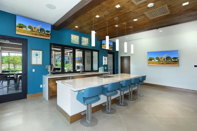 a large dining hall with stainless steel appliances granite countertop breakfast area