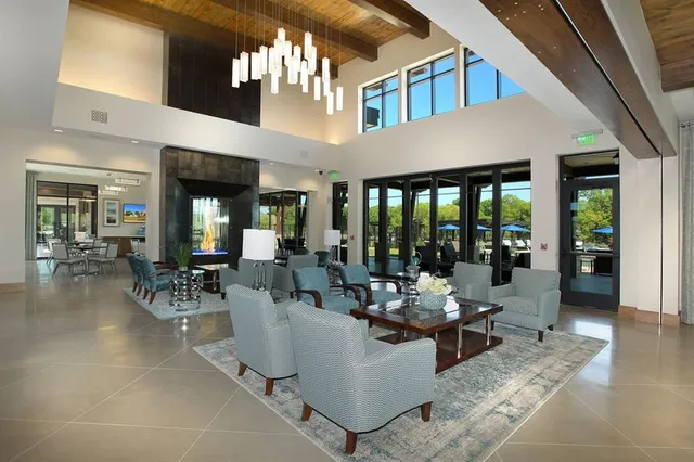 a living room with furniture and large windows