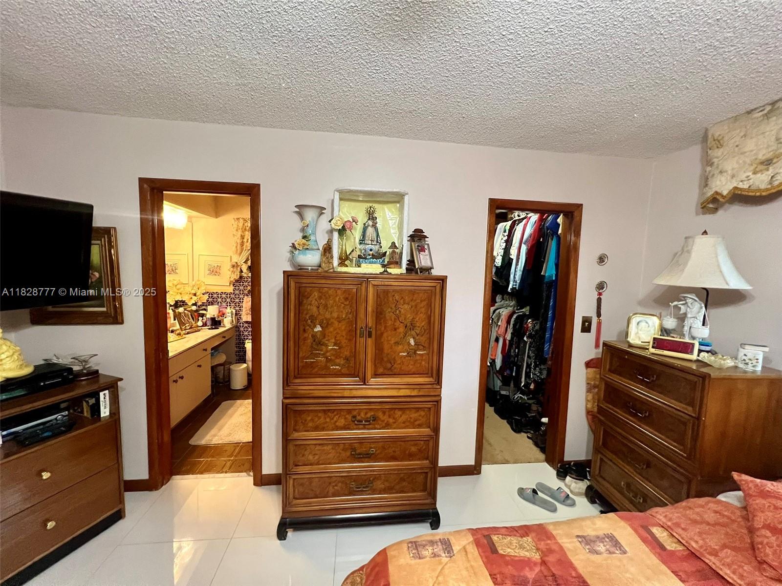 9601 Southwest 66th Street Miami, FL 33173 - Photo 16 of 52 a view of walk in closet with clothes and shoes
