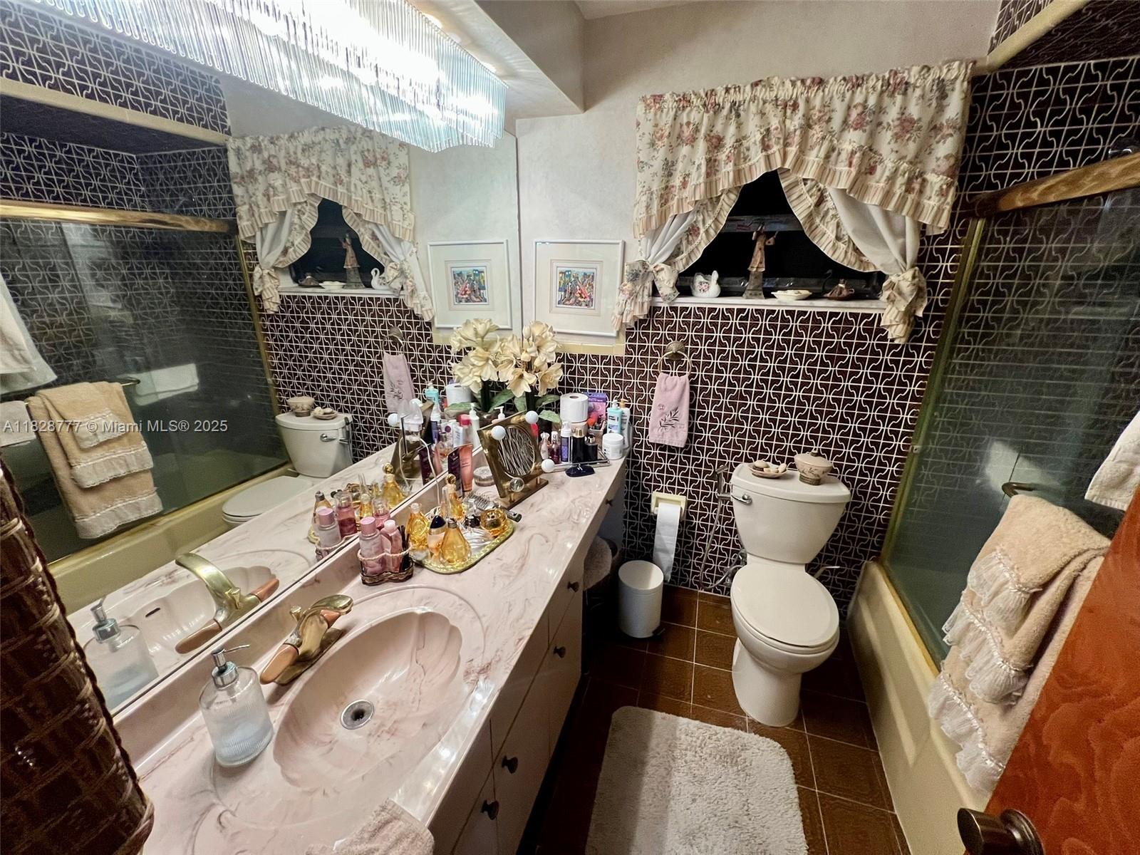 9601 Southwest 66th Street Miami, FL 33173 - Photo 17 of 52 a bathroom with a sink toilet and shower