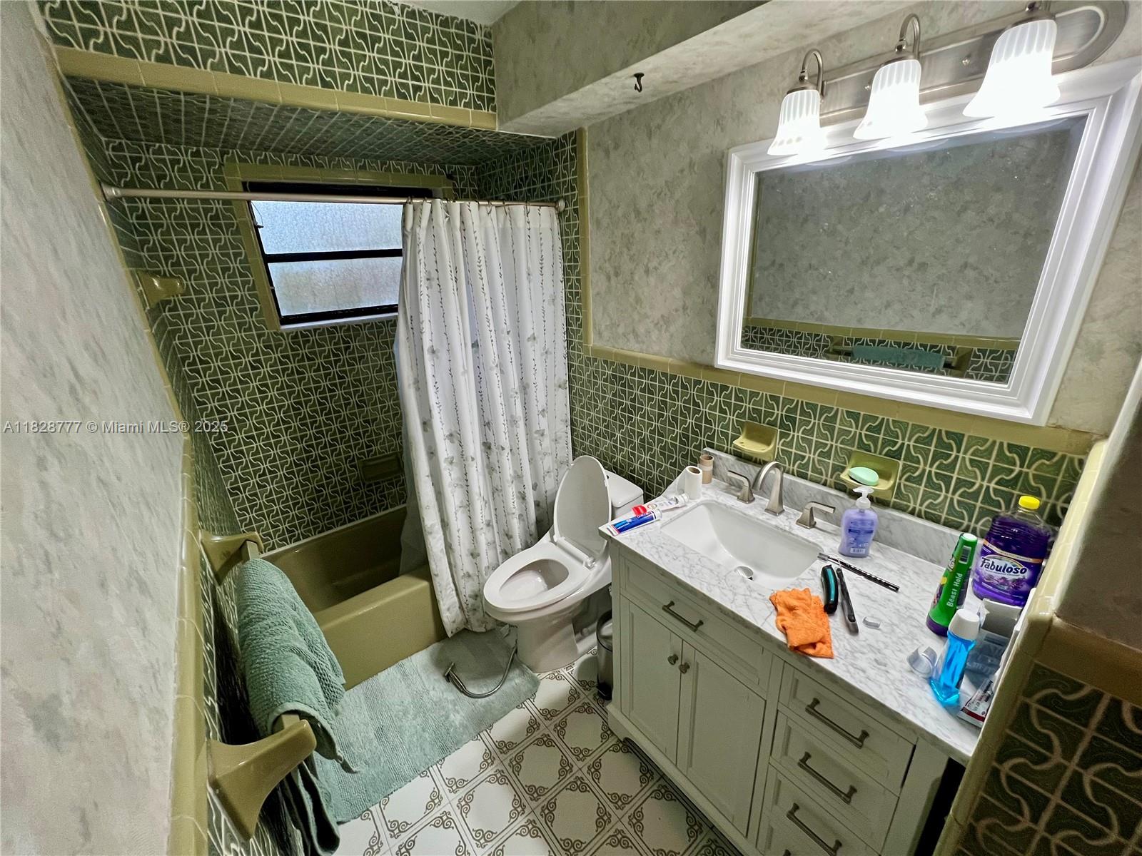 9601 Southwest 66th Street Miami, FL 33173 - Photo 19 of 52 a bathroom with a sink toilet and mirror