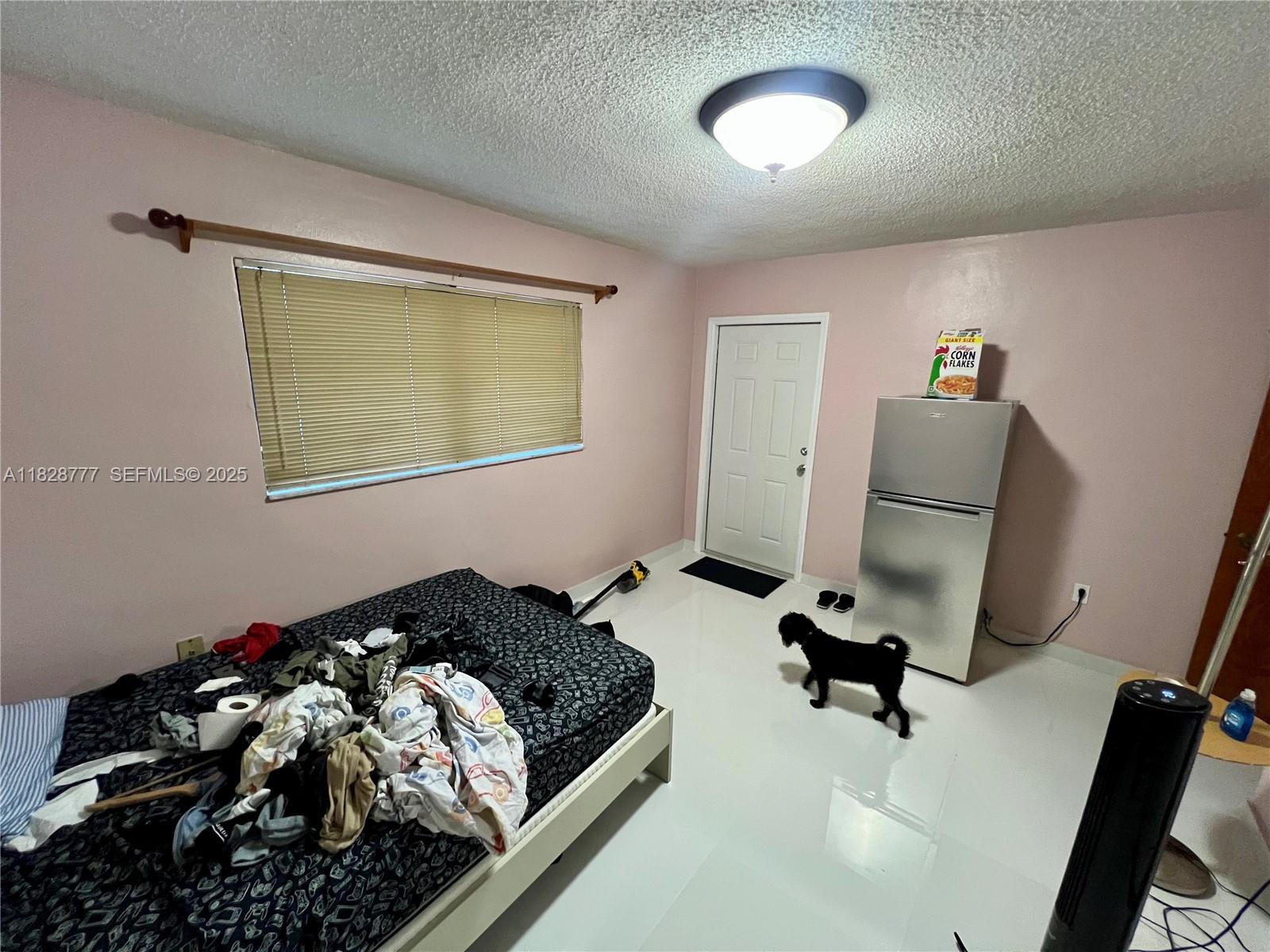 9601 Southwest 66th Street Miami, FL 33173 - Photo 22 of 52 a bedroom with a bed and a window