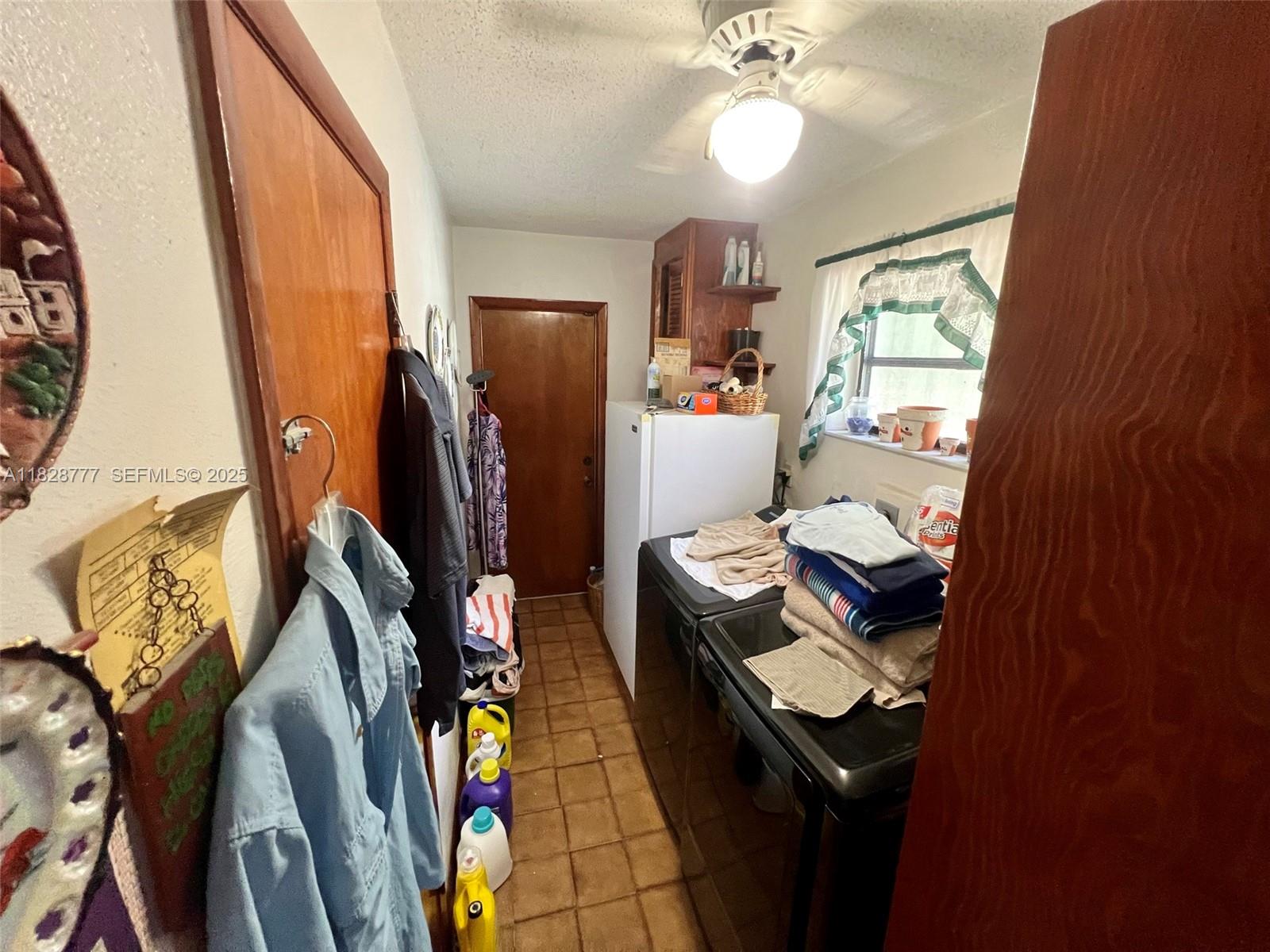 9601 Southwest 66th Street Miami, FL 33173 - Photo 25 of 52 a view of walk in closet with clothes and shoes