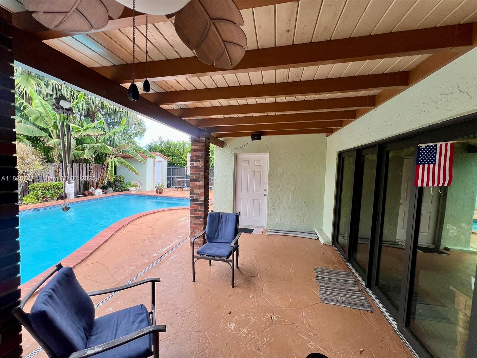 9601 Southwest 66th Street Miami, FL 33173 - Photo 28 of 52 a view of a porch with furniture and a yard
