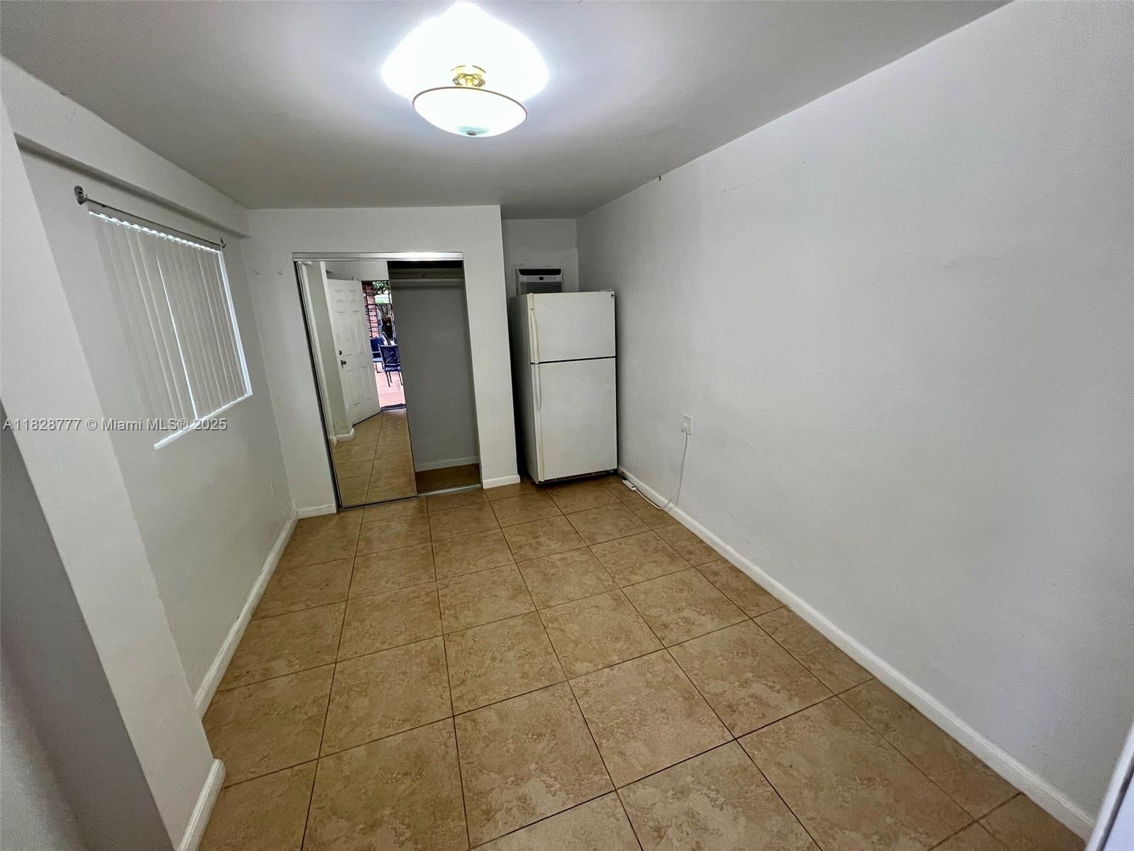 9601 Southwest 66th Street Miami, FL 33173 - Photo 29 of 52 an empty room with closet and mirror