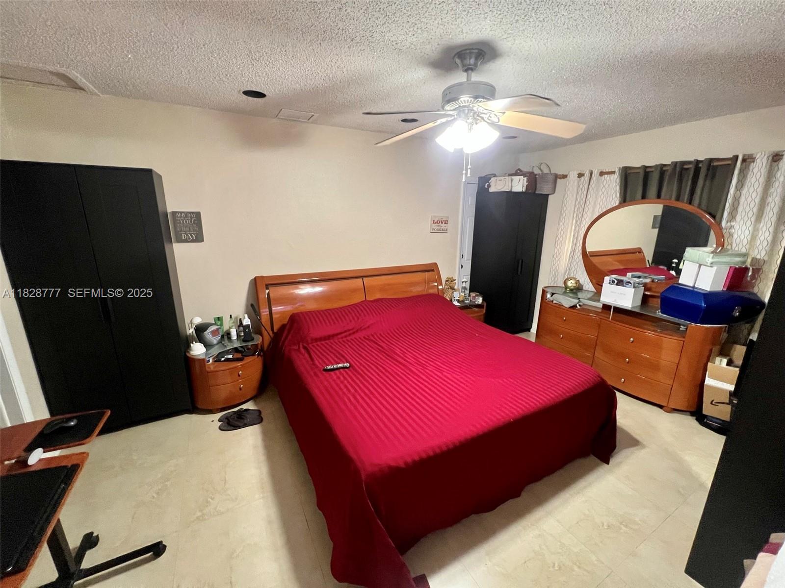 9601 Southwest 66th Street Miami, FL 33173 - Photo 34 of 52 a bedroom with a bed and a mirror