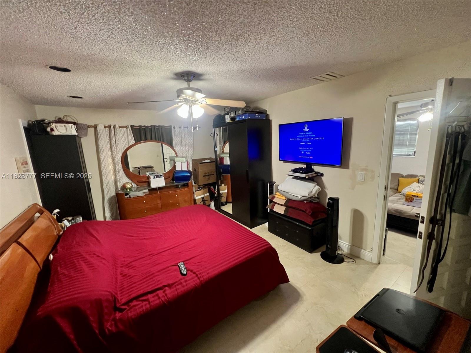 9601 Southwest 66th Street Miami, FL 33173 - Photo 35 of 52 a bed room with a bed mirror and a chair