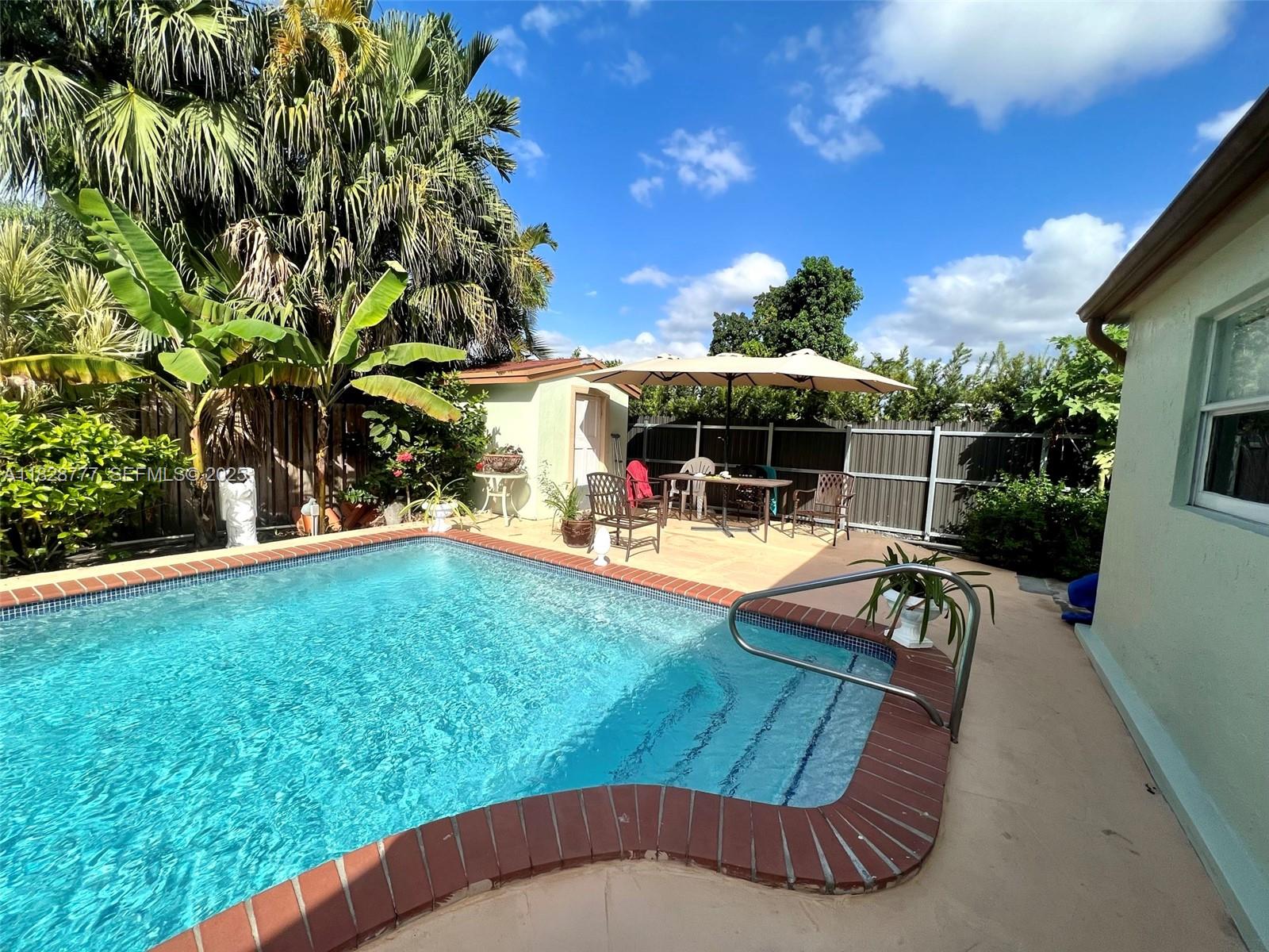 9601 Southwest 66th Street Miami, FL 33173 - Photo 37 of 52 a view of a swimming pool with a patio