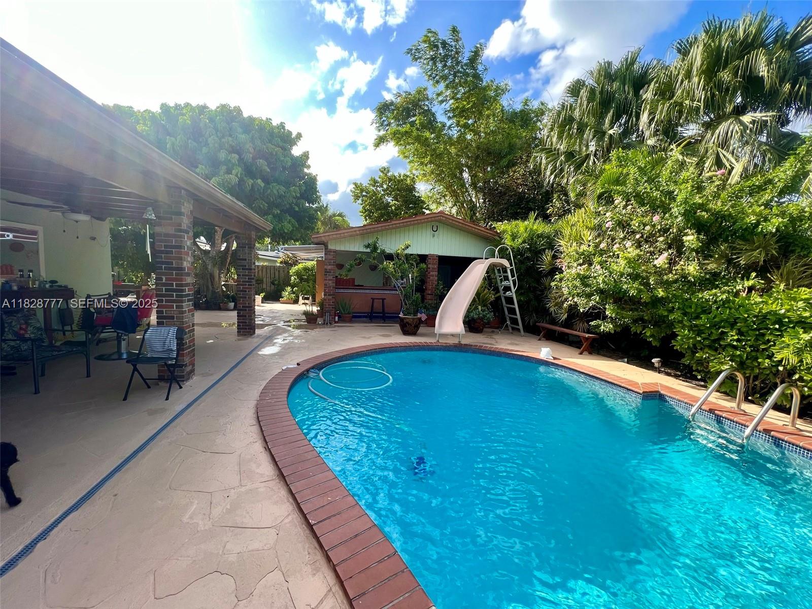 9601 Southwest 66th Street Miami, FL 33173 - Photo 40 of 52 a swimming pool with outdoor seating and yard