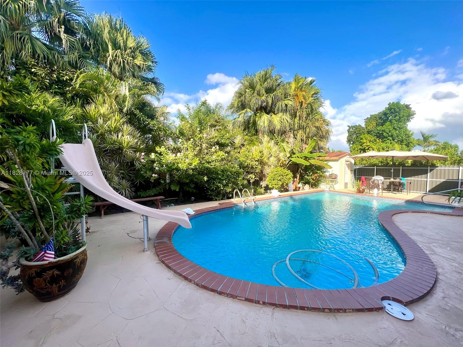 9601 Southwest 66th Street Miami, FL 33173 - Photo 50 of 52 a view of a swimming pool with an outdoor seating