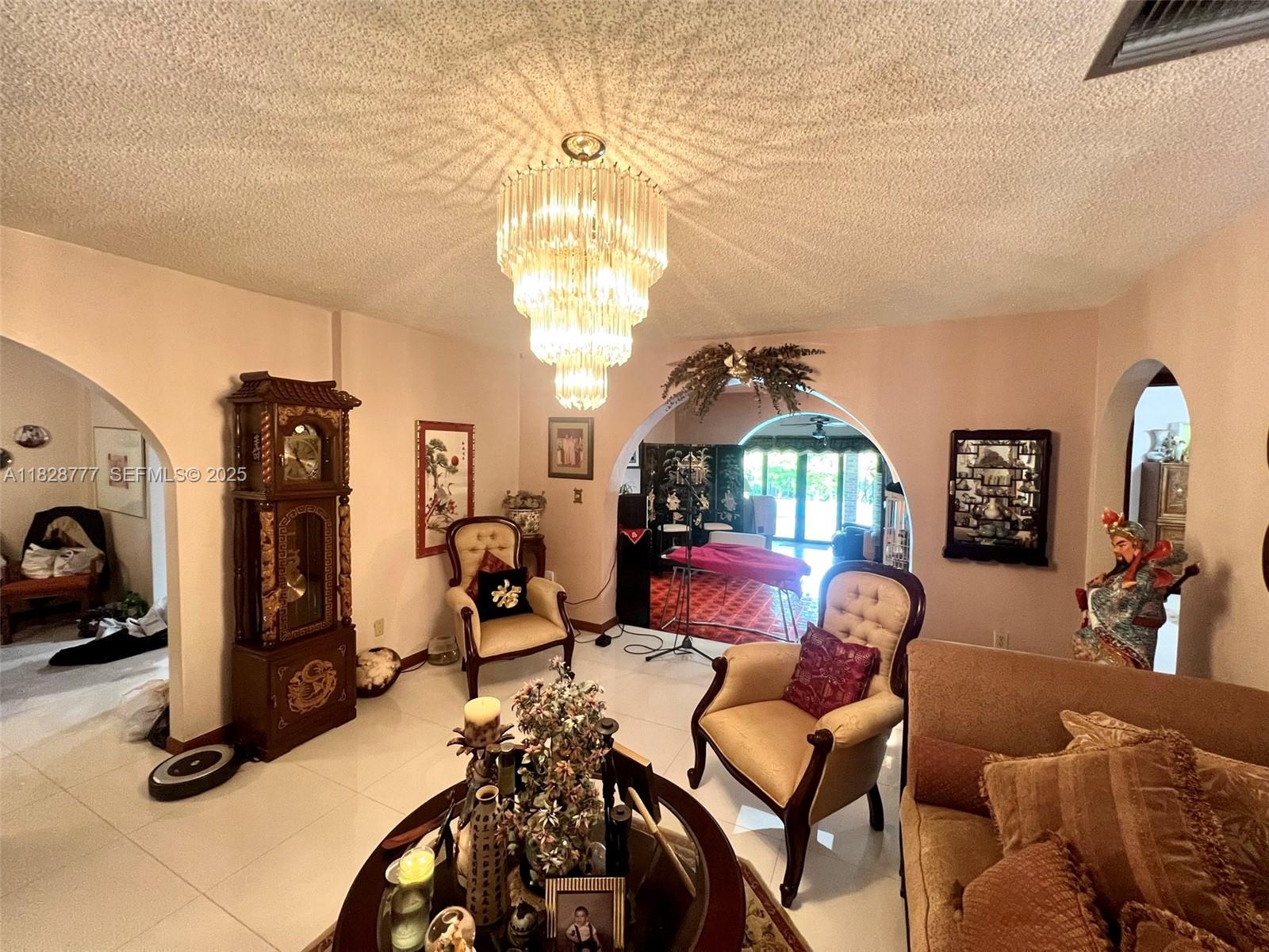 9601 Southwest 66th Street Miami, FL 33173 - Photo 6 of 52 a view of a livingroom with furniture and a chandelier