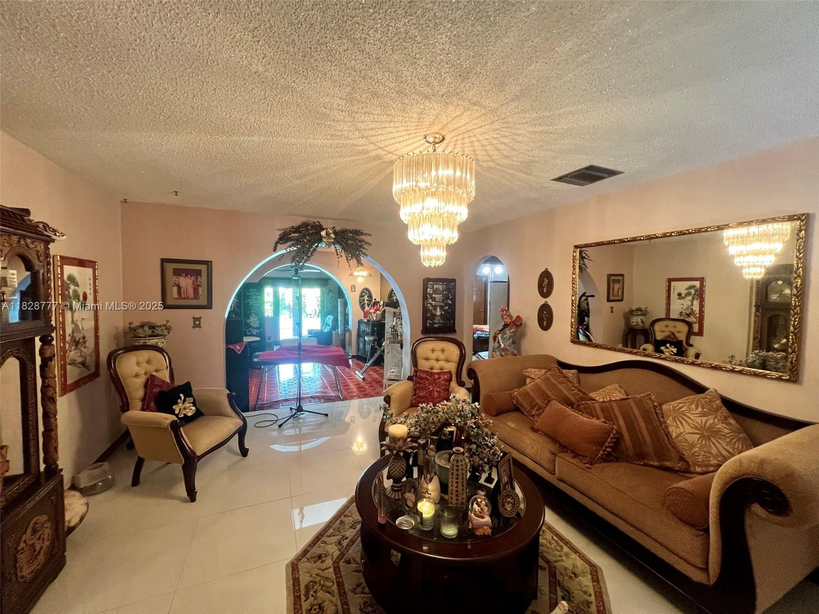 9601 Southwest 66th Street Miami, FL 33173 - Photo 7 of 52 a living room with furniture and a chandelier