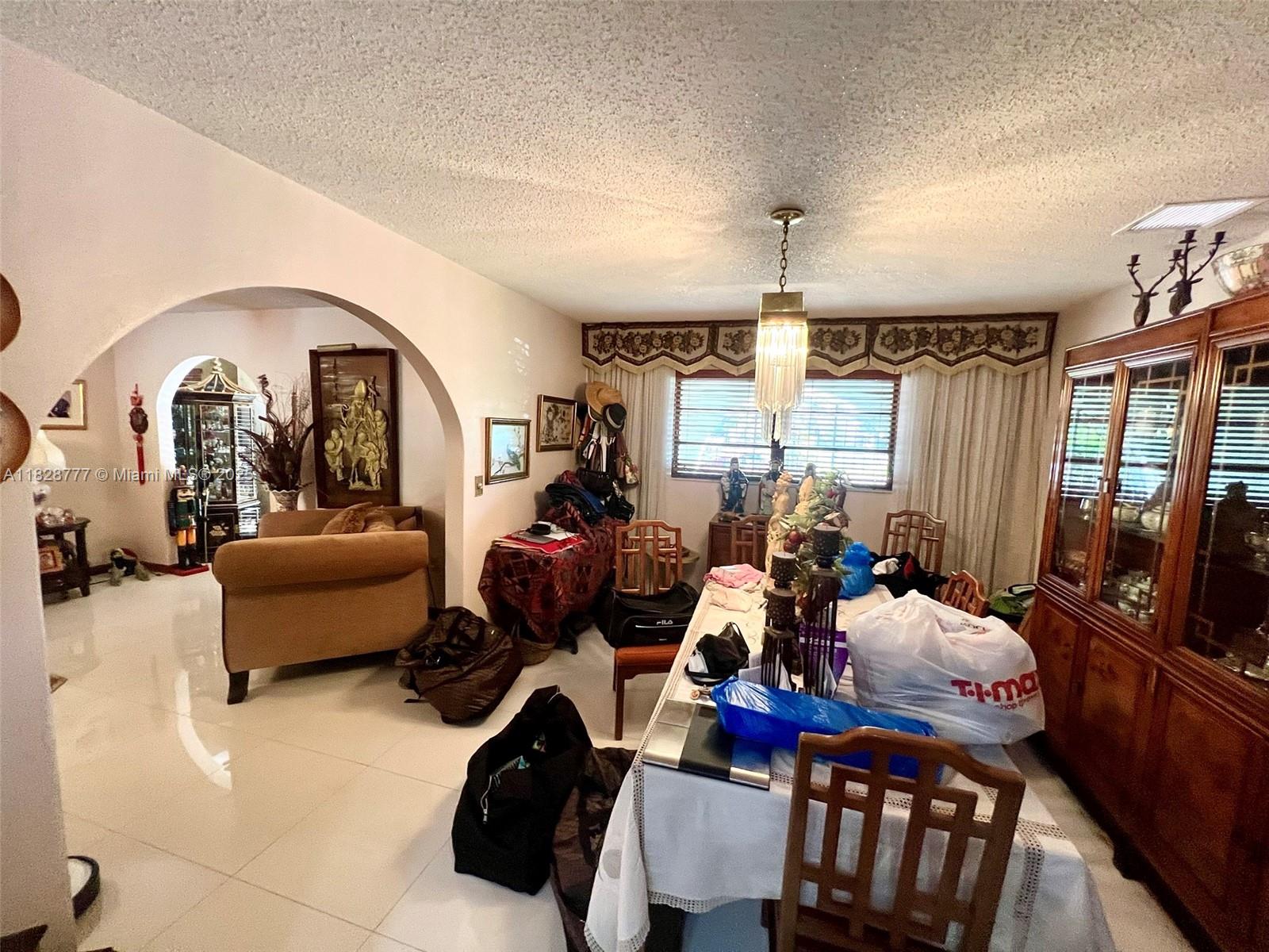 9601 Southwest 66th Street Miami, FL 33173 - Photo 8 of 52 a living room with furniture fireplace and large windows