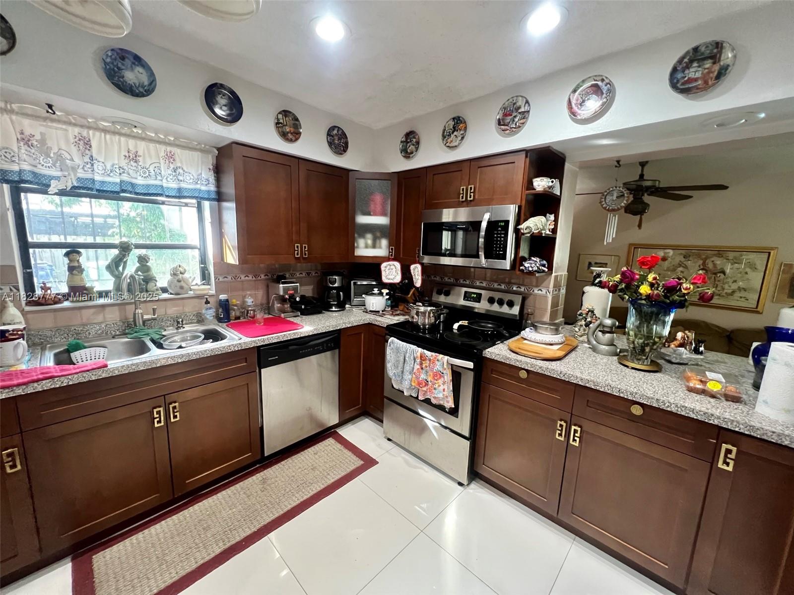 9601 Southwest 66th Street Miami, FL 33173 - Photo 9 of 52 a kitchen with a sink stove and cabinets