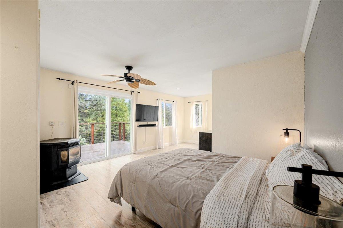 2227 Swansboro Road Placerville, CA 95667 - Photo 14 of 59 a bedroom with a bed and a chandelier