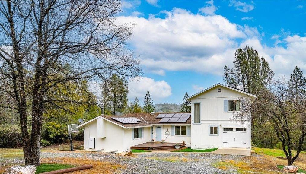 2227 Swansboro Road Placerville, CA 95667 - Photo 2 of 59 a view of a white house next to a yard with big trees