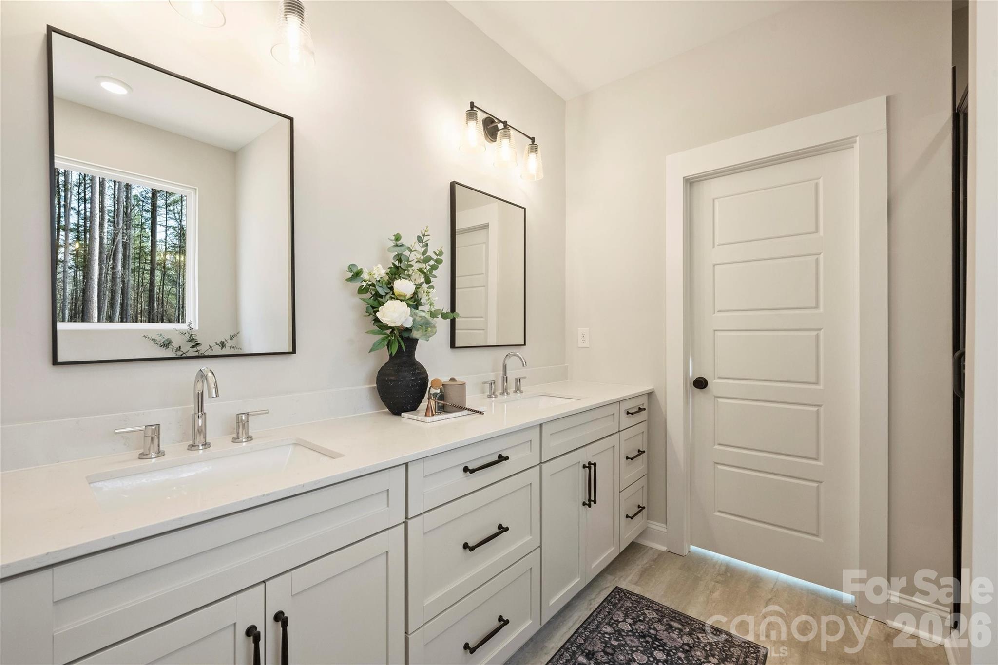 2279 Lee Lawing Road Lincolnton, NC 28092 - Photo 24 of 41 a bathroom with a double vanity sink and mirror