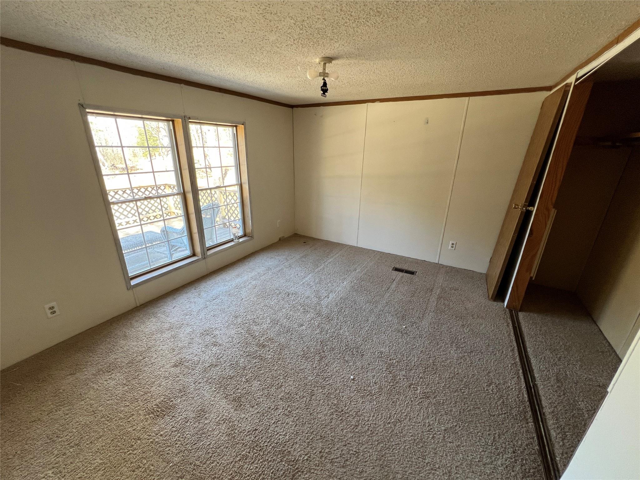 734 Shaver Hollow Road Andes, NY 13731 - Photo 6 of 9 Unfurnished bedroom featuring light colored carpet, a textured ceiling, visible vents, and ornamental molding